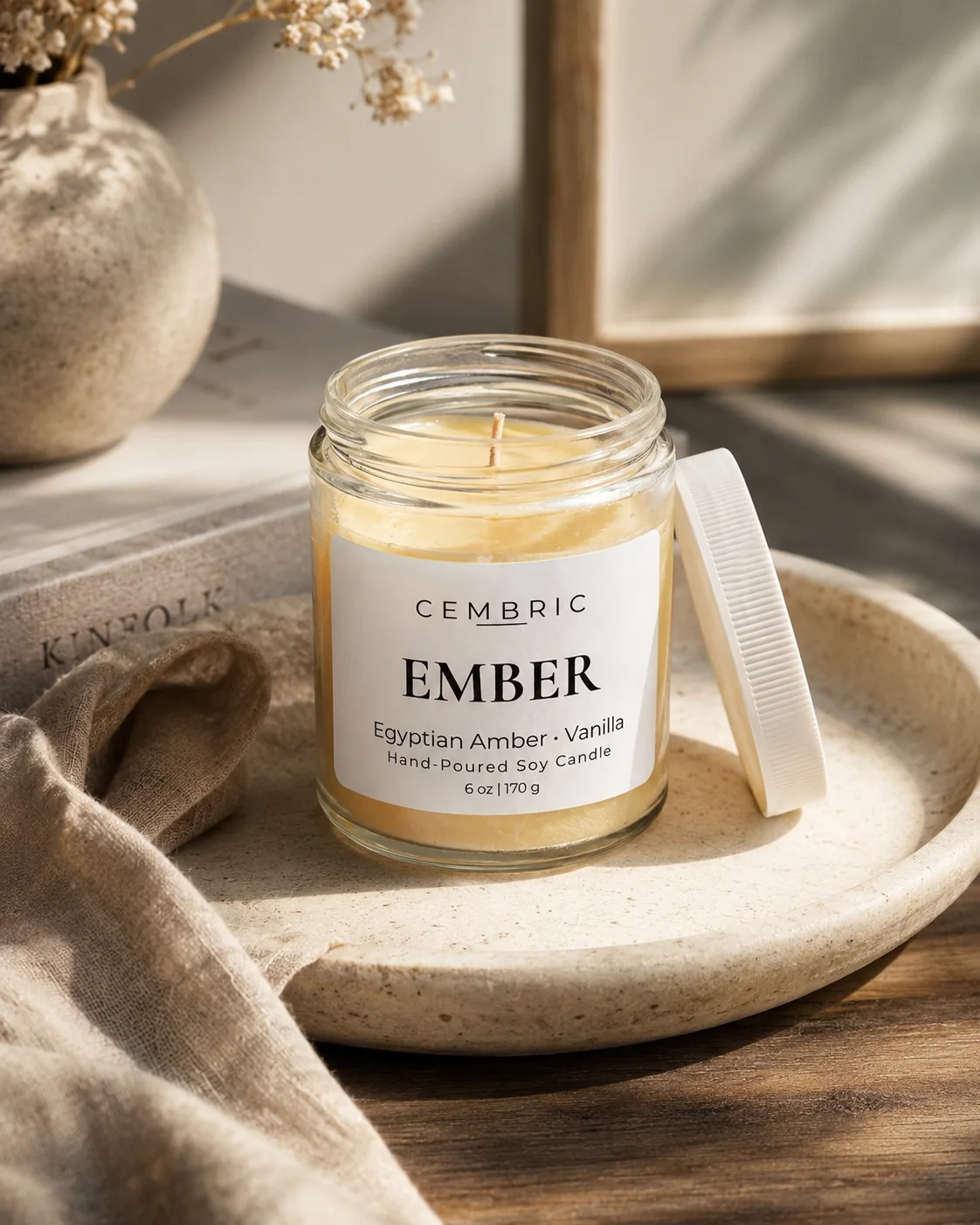 EMBER hand-poured soy candle styled on a warm neutral tray