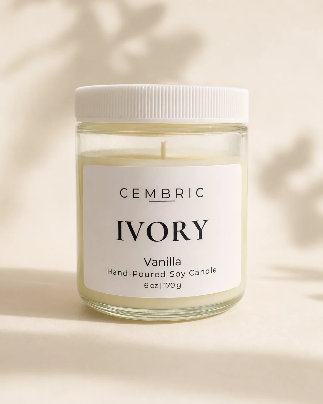 IVORY pure vanilla candle in a clear glass jar with a white lid
